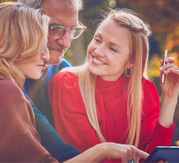 young woman holding a heet smiling at her parents